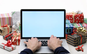 Man buys christmas gifts - online shopping concept